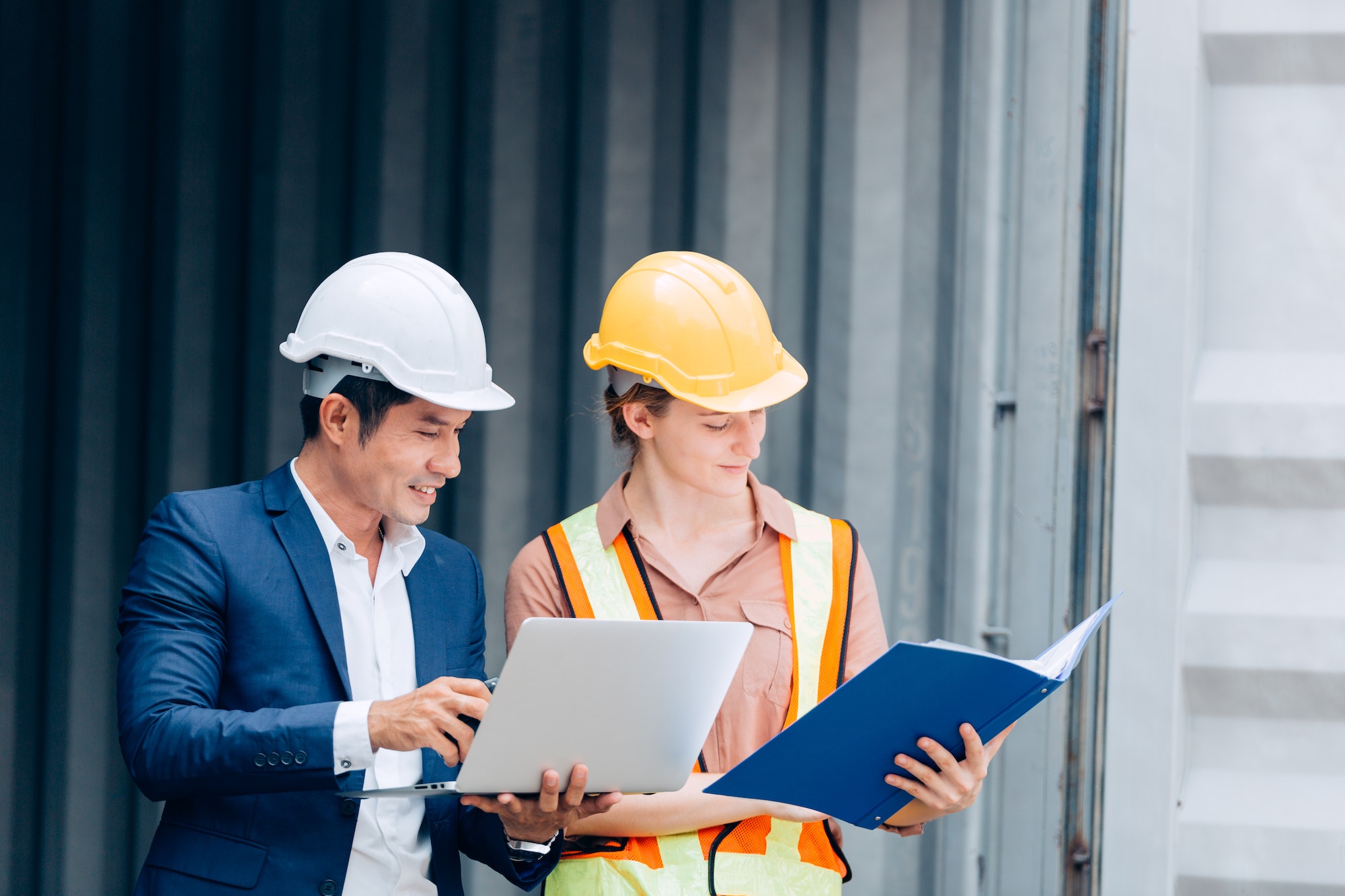 foreman working with female engineer at construction site